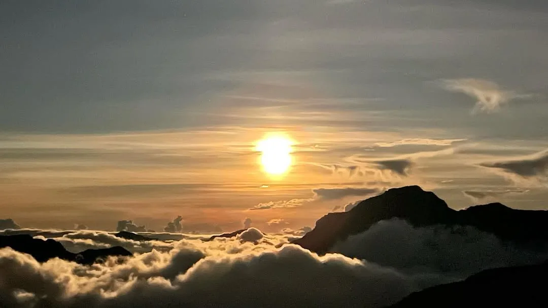 Golden sunlight over mountain clouds